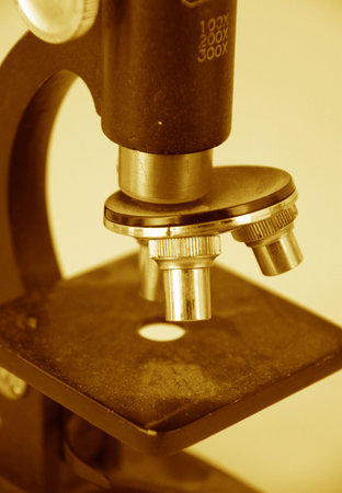 antique small microscope in sepia signifying scientific discovery and science の写真素材