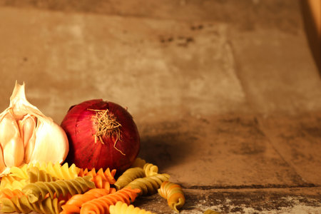 Pasta with ingredients on stone backgroundの写真素材