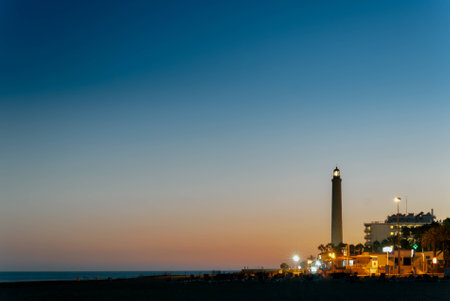 The Maspalomas' lighthouse at sunset in Grand Canary islandの写真素材