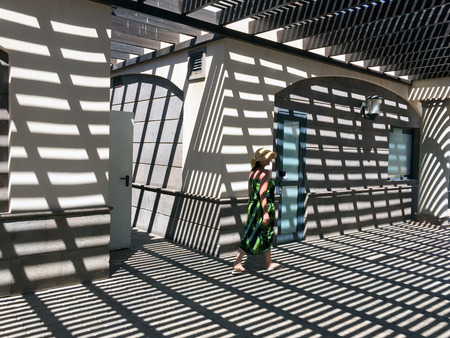 A shot of a woman under light and shadowsの写真素材