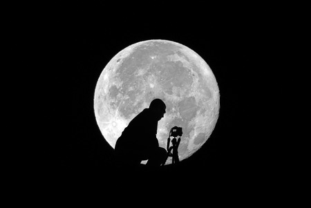 A self portrait taking a photo of the supermoonの写真素材