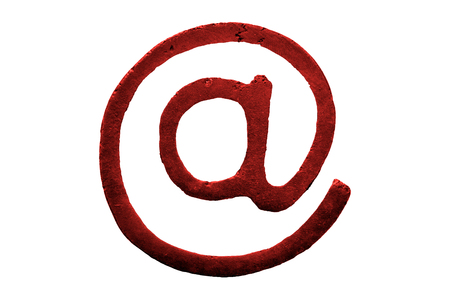 A macro and isolated shot of a bronze computing arroba symbol (at sign)の写真素材