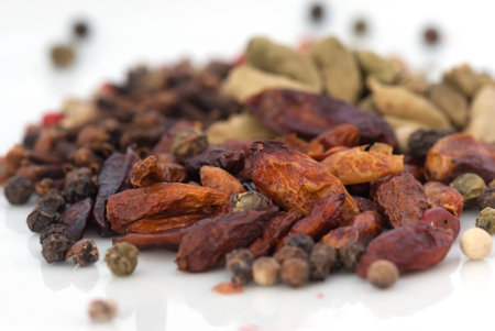 A macro species beans composition of different colors and textures (cardamom, pepper, cloves, chillies and cinnamon)の写真素材