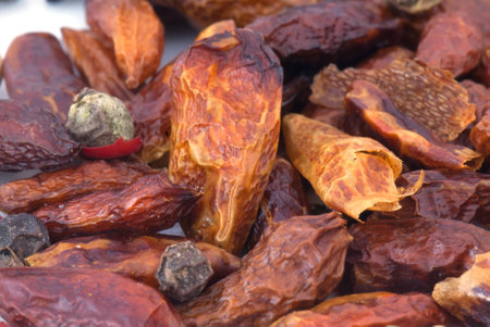 A macro species beans composition of different colors and textures (cardamom, pepper, cloves, chillies and cinnamon)の写真素材