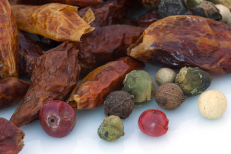 A macro species beans composition of different colors and textures (cardamom, pepper, cloves, chillies and cinnamon)の写真素材