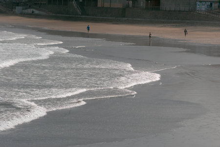 A shot of several people walking on the beach