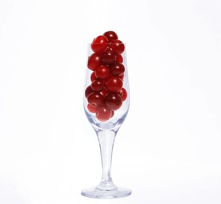 Goblet full of cranberries isolated on white backgroundの写真素材