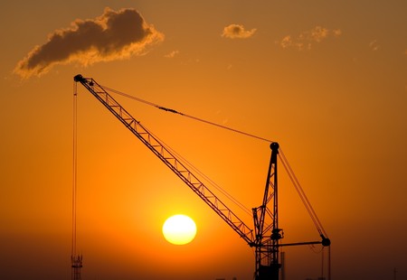 Silhouette of crane at the sunriseの写真素材