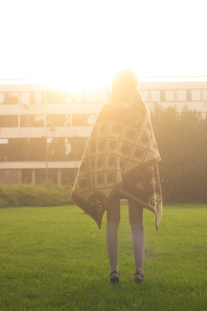 Rear view, girl standing strong  sunlight.の写真素材