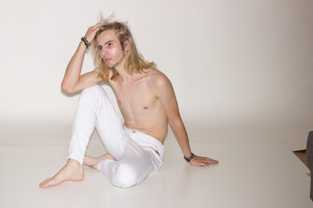 young man model snapshot sitting posingの写真素材