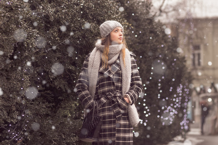 snowing young woman outdoors winter, fancy winter clothes snowの写真素材