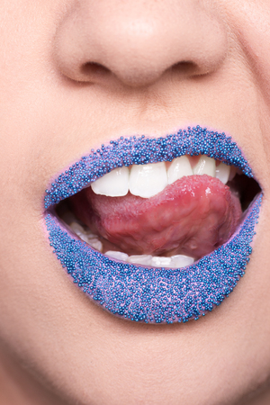 woman, blue lipstick, tongue mouth closeup lips, tongue extended out, accessories, unrecognizable personの写真素材