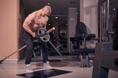 one bodybuilder, T-bar row, gym indroors exercise, muscular strong.の写真素材