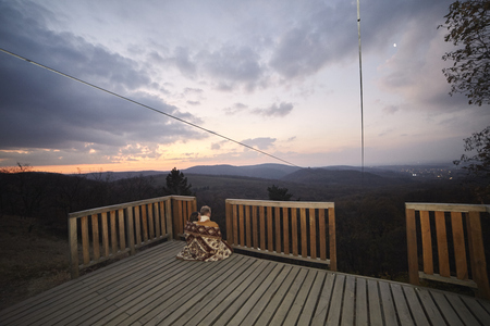 one young couple, two friends hugging together under a blanket. relaxing in urban area, outdoors in beautiful scenery landscape (national park "Fruska Gora", Serbia). Wide angle shot whole environmentの写真素材