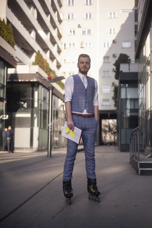 one young businessman, wearing suit and inline skates at same time, eccentric style, fashionable and trendy. Full length portrait in business district.の写真素材