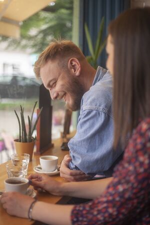 smiling happy friends, together in a cafe.の写真素材