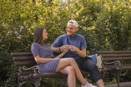 Happy young couple enjoys spring day in park. Holding hands.の写真素材