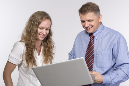 Man and woman are laughing in the officeの写真素材
