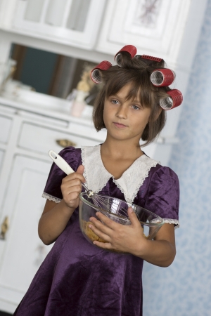 Young girl plays a retro housewifeの写真素材