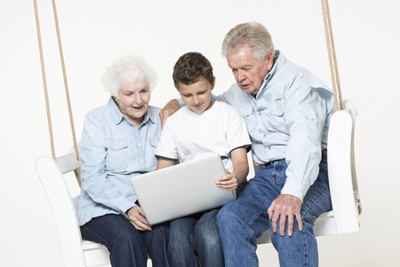 Grandson helps his grandparents with computer problemの写真素材