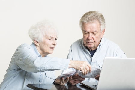 Senior couple is concerned with billsの写真素材