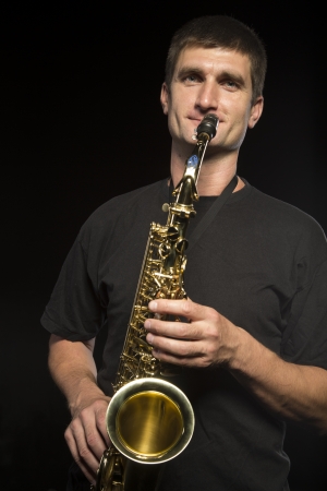 Young man plays saxophoneの写真素材
