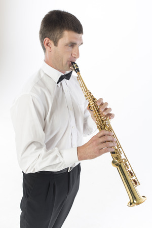 Young handsome man plays saxophoneの写真素材