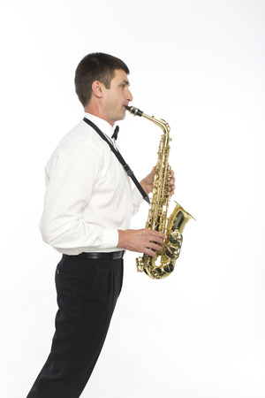 Young handsome man plays saxophoneの写真素材