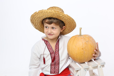 Ukrainian boy holds a pumpkinの写真素材