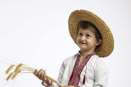 Young smiling boy in straw hatの写真素材