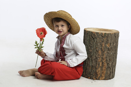Boy in ethnic clothing with flowerの写真素材