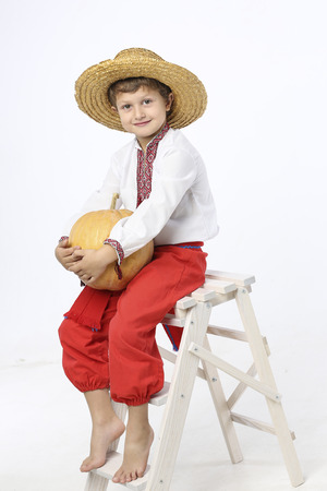 Farmer boy with a pumpkinの写真素材