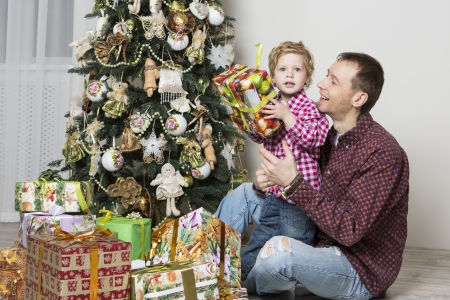 Father gives his son Christmas giftの写真素材