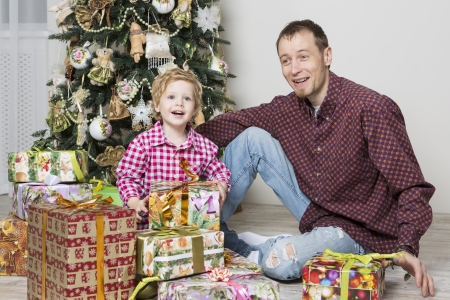 Father gives his son Christmas giftの写真素材