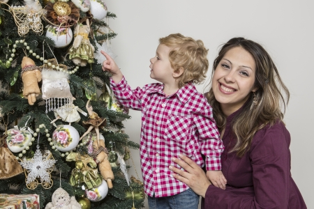 Mother and son under Christmas treeの写真素材