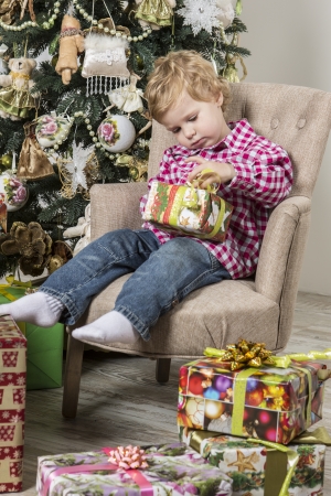 Boy opens Christmas giftの写真素材