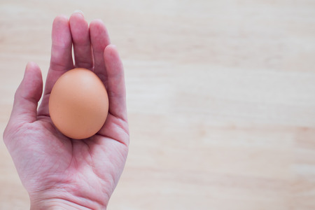 The chicken egg in the hand. Easter time, Happy time. Jesus rise again.の写真素材