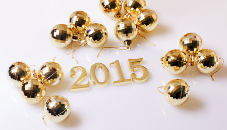 Christmas decorations and figures gold color on a white backgroundの写真素材