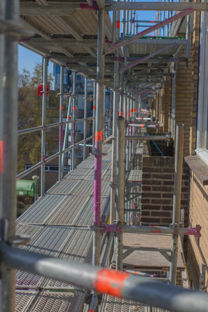 Scaffolding used as a temporary structure to support the building structure and a work platform for...
