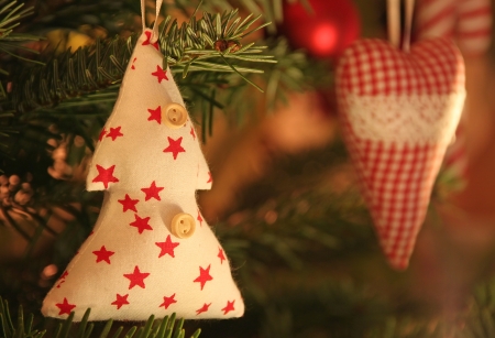 Christmas tree and fabric heart in reflective lightの写真素材