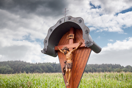 A wooden wayside cross - wayside cross in Rehling and Aindling in Bavaria - Germanyの写真素材