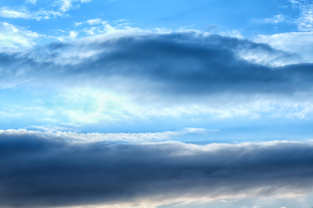 Turbulent perspectives - Dramatic clouds sky dark clouds and bright blueの写真素材