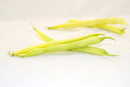 Fresh and crispy yellow beans with leaves  on a white background.の写真素材