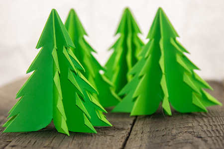 Origami Christmas tree on a wooden baseの写真素材