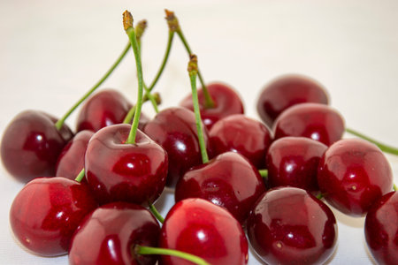 It's spring! Red, ripe, fresh cherry on a white background.