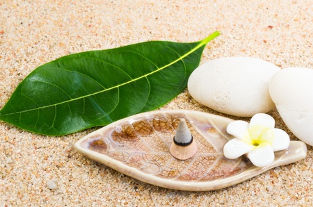 Burning incense cone on sand spaの写真素材