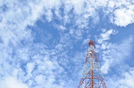 The telecommunications tower with beautiful cloudsの写真素材