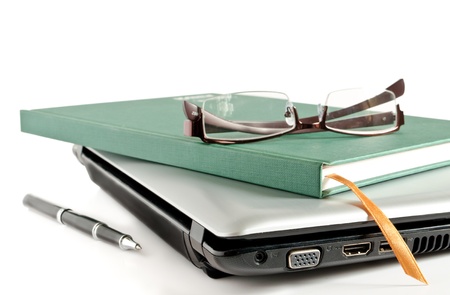 Glasses and Green Book put on Laptopの写真素材