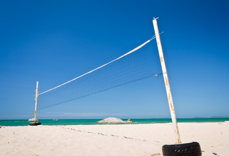 A beach volleyball net on a sunny day with blue skyの写真素材