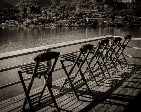 bamboo chairs on a beautiful lake in morning time, Ban Rak Thai, a Chinese settlement in Mae Hong Son province, Northern Thailand.の写真素材